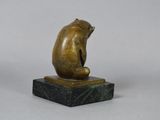 bronze sculpture of a bear sitting on a marble base