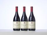 three bottles of wine sitting on top of a table next to each other