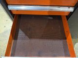 a metal drawer with an open drawer underneath it
