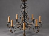 a large wrought iron chandelier with five candles