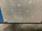 a close up of a piece of metal with a sign on it
