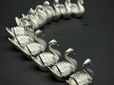 un bracelet en argent orné d'une volée d'oiseaux
