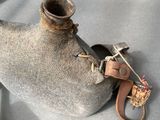 a large metal object on a table with a pair of shoes