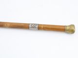 a wooden baseball bat with a metal handle on a white surface