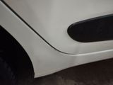 a close up of a white car with a black door handle