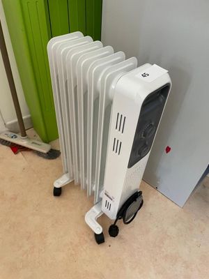 a white radiator sitting next to a green radiator