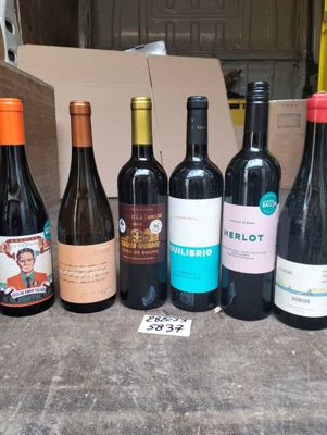 several bottles of wine are lined up in a row on a table
