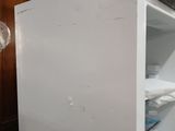 a white refrigerator that is sitting in the corner of a room