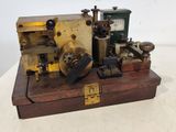 a small machine that is sitting on top of a wooden box