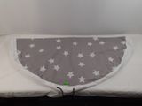 a bed with a white and grey cover on it