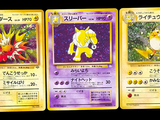 three pokemon cards with different designs on them on a black background