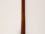 an old wooden pipe with a wooden handle on a white surface
