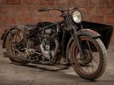 a old motorcycle that is parked in front of a brick wall
