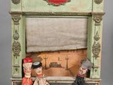 dolls are sitting in a display case on a gray surface