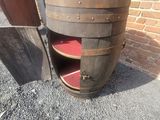 a close up of a wooden barrel with a shelf underneath it