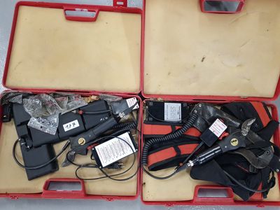 a red case with tools inside of it on a table