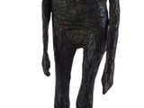 statue of a man with a hat on his head standing on a green base