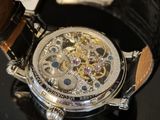 a close up of a watch on a black surface