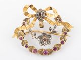 an image of a broochle with a bow and flowers on it