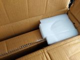 a cardboard box with a white shirt inside of it