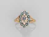 a gold ring with blue and white diamonds