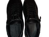 black leather sneakers with laces on the toes and a rubber sole