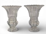 pair of clear glass vases on a white surface with a white background