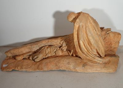 statue d'une femme assise sur un rocher, la tête baissée