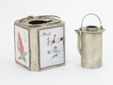 a small silver teapot next to a small silver teapot