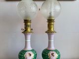 two lamps that are sitting on a table next to a painting
