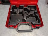 a red tool box with tools in it on a table