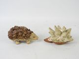 two small figurines of a hedge and a hedgehog