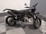 a picture of a black and yellow motorcycle parked on a checkered floor