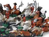 many figurines of people riding horses and dogs