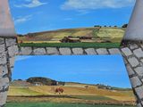 deux tableaux représentant un champ avec des vaches au loin et un ciel bleu