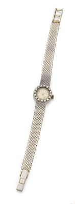 a close up of a wrist watch on a white surface