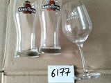 three empty wine glasses sitting on top of a cardboard box
