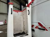 a white van parked in a garage with a red handle