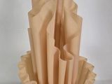 a vase that has a bunch of folded paper in it