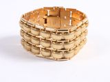 bracelet made of gold - plated metal on a white background