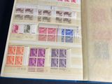 an open book with stamps on it sitting on top of a table
