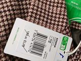 a tag attached to a brown and black jacket