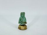 an image of a statue of a person sitting on top of a rock