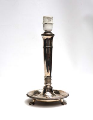 an image of a silver candle holder with a white light on top of it