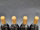 three bottles of wine are lined up on a table