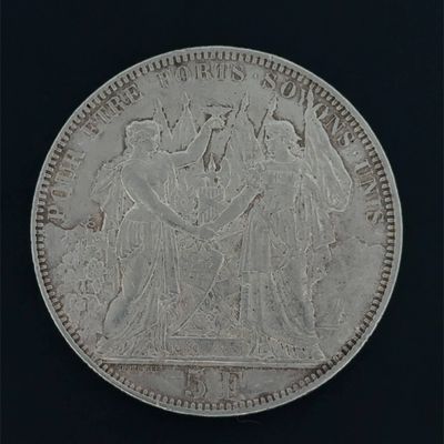 a close up of a silver coin on a black background