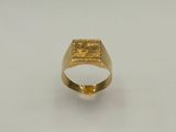 gros plan d'une bague en or sur une surface blanche