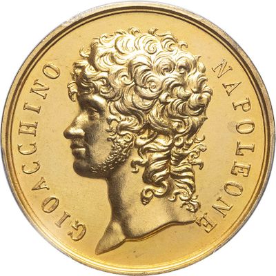 a close up of a gold coin with a woman ' s head on it