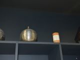 two vases sitting on top of a shelf in a room