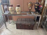 three vases and a trunk on a glass table
